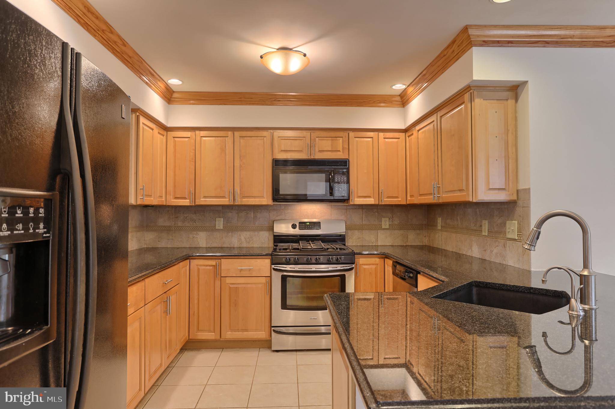 Zoom into the gorgeous backsplash, solid wood cabs