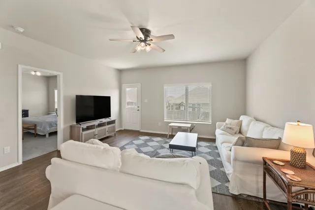 a living room with furniture and a flat screen tv