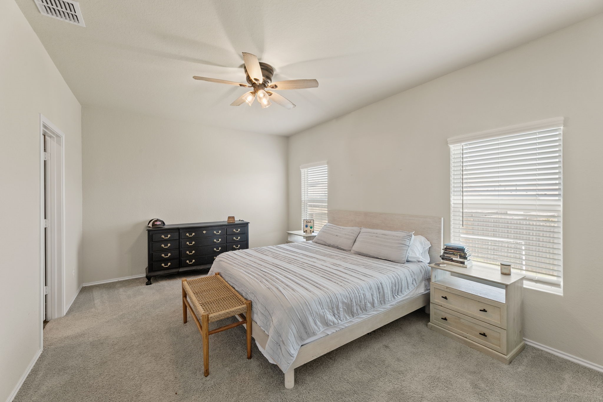 3969 Legend Ranch New Braunfels, TX 78130 - Photo 16 of 32 a bedroom with a bed and a chandelier