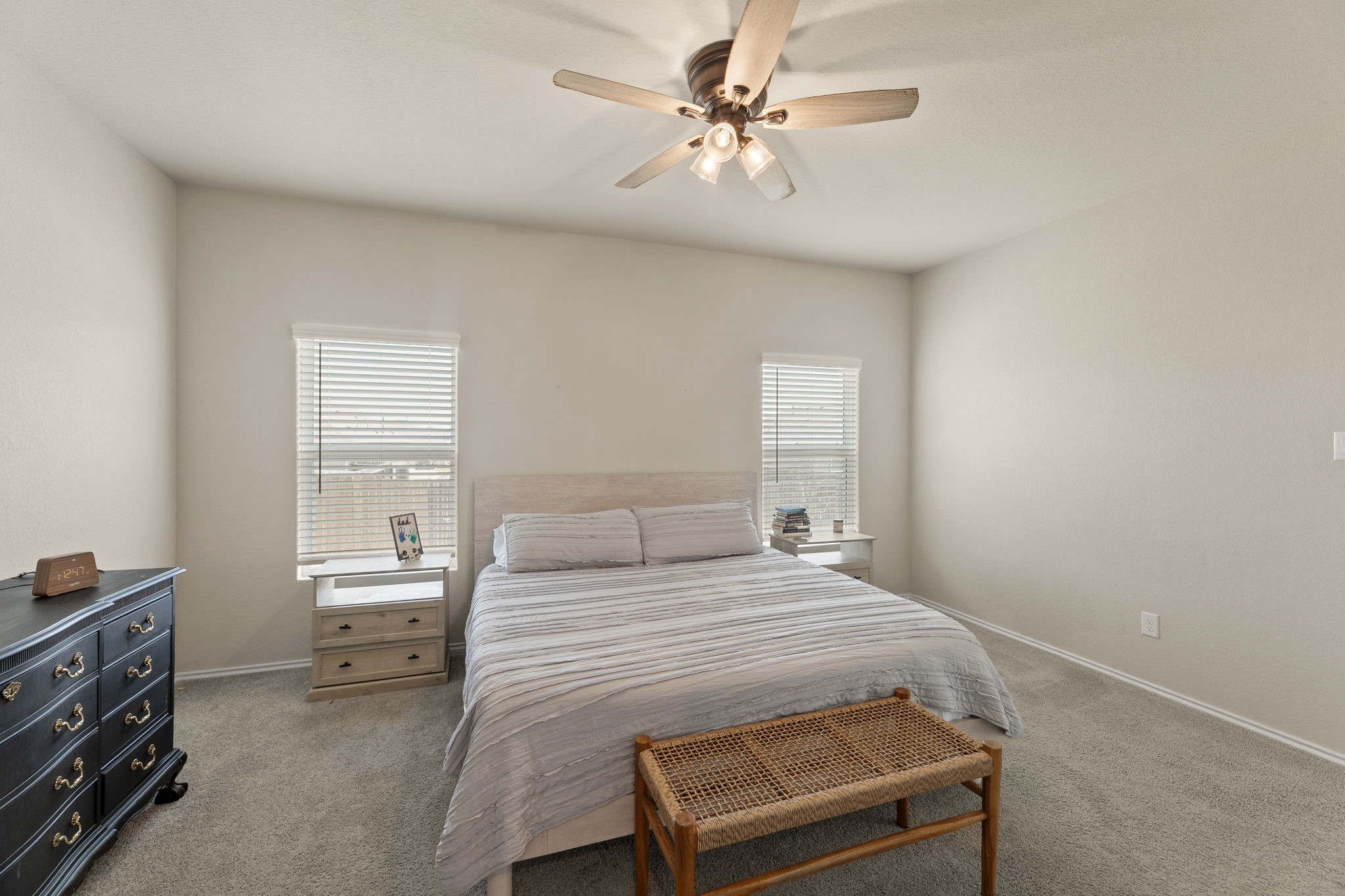 3969 Legend Ranch New Braunfels, TX 78130 - Photo 18 of 32 a bedroom with a bed a chandelier and a window