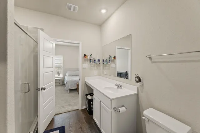 a view of a bathroom with a sink mirror and toilet