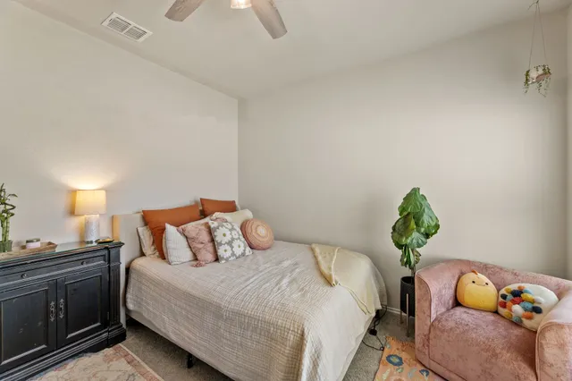 a bedroom with a bed and ceiling fan