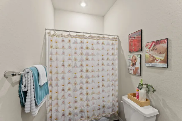 a bathroom with a shower and a toilet