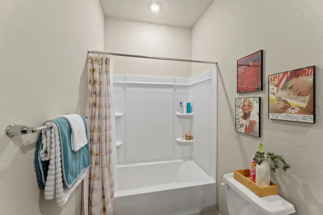 a bathroom with a bathtub and shower