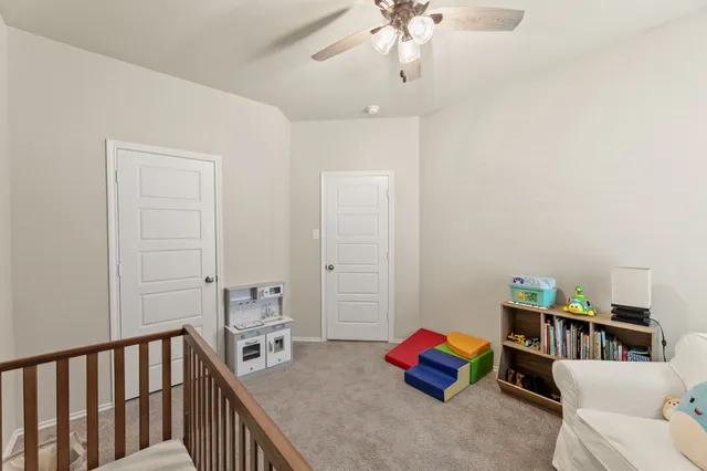 a bedroom with furniture and a book shelf