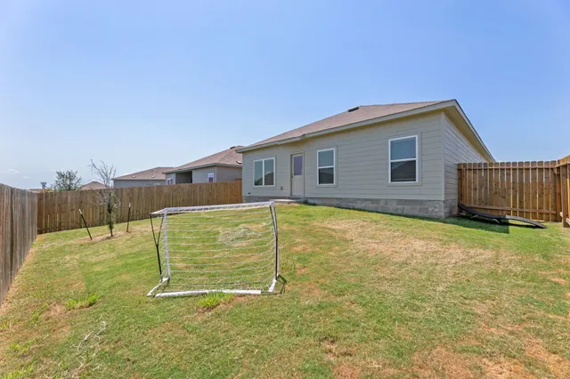 a house view with a backyard space