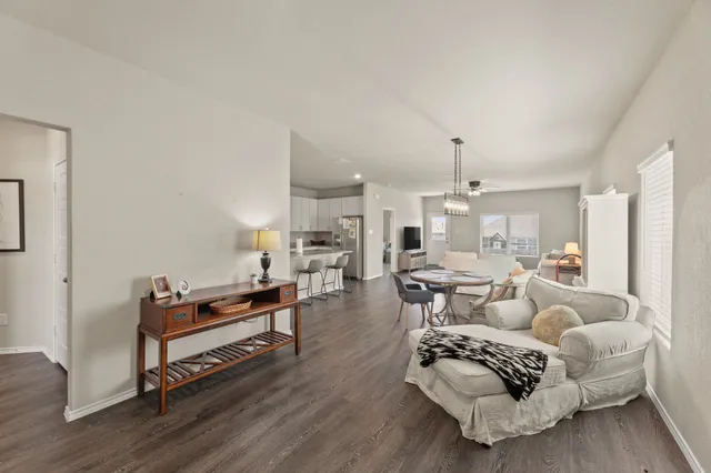 a living room with furniture a rug and white walls