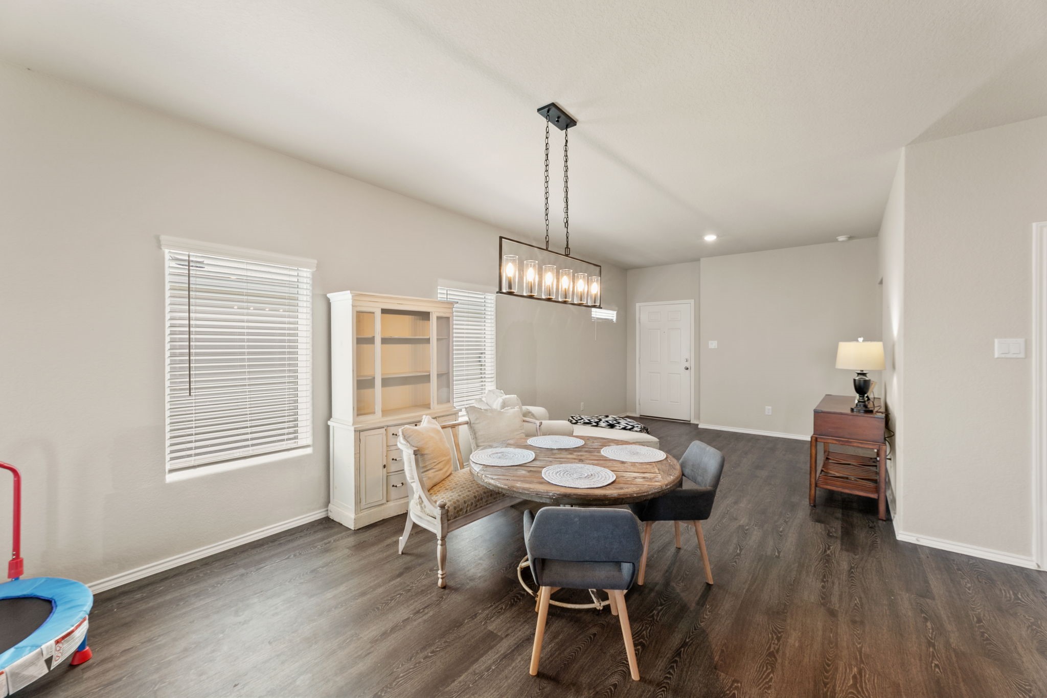 3969 Legend Ranch New Braunfels, TX 78130 - Photo 6 of 32 a dining room with furniture a chandelier and wooden floor
