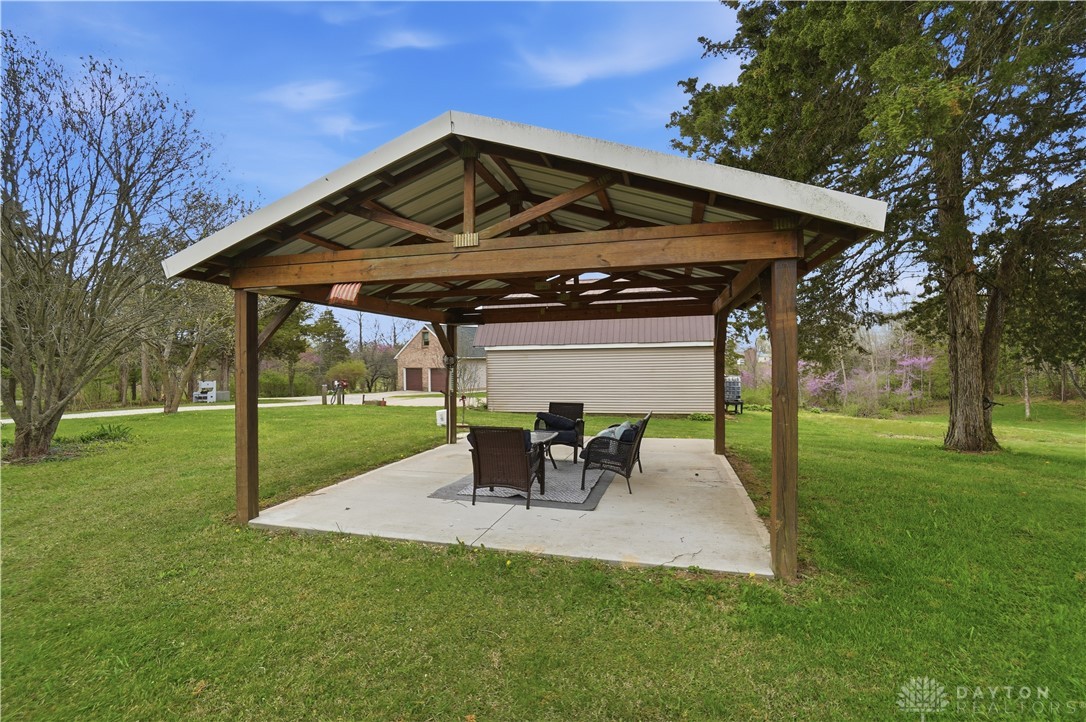 7553 Coffin Station Road Springfield, OH 45502 - Photo 17 of 95 An inviting covered patio area offers a perfect spot for outdoor relaxation and entertaining.