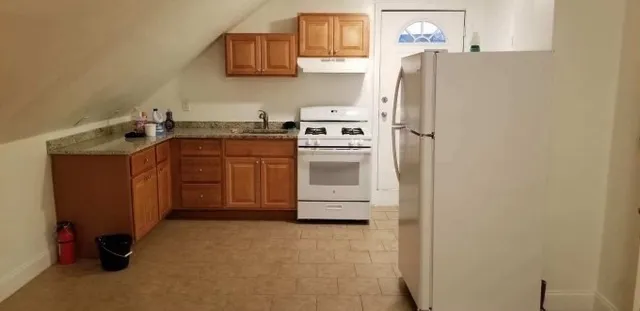 a kitchen with stainless steel appliances a refrigerator sink and stove
