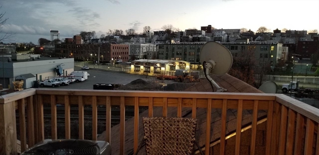 61 Crescent Street, Unit 3 Chelsea, MA 02150 - Photo 9 of 12 a view of a balcony with wooden benches