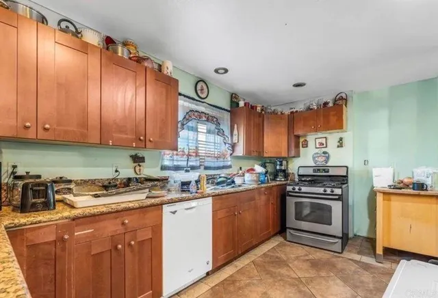 a kitchen with a sink a stove and cabinets