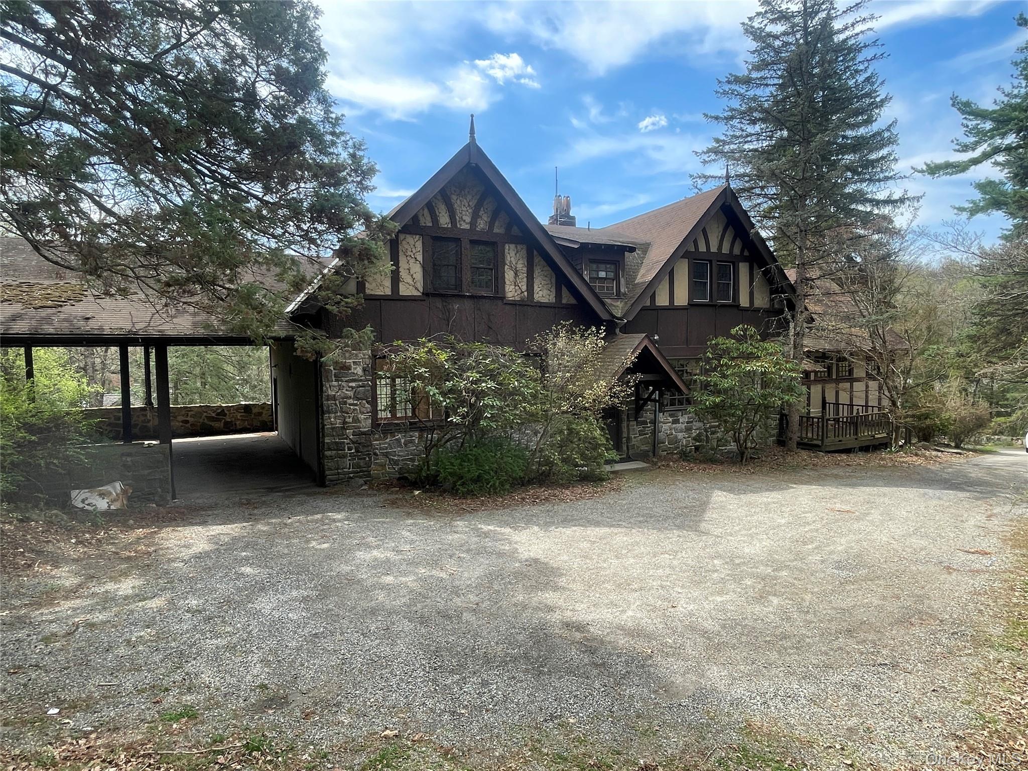 32 East Lake Stable Road Tuxedo Park, NY 10987 - Photo 1 of 49 a front view of a house with a garden