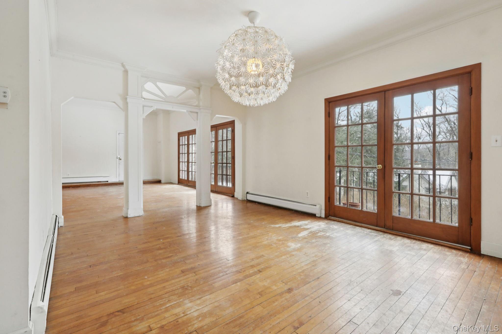 32 East Lake Stable Road Tuxedo Park, NY 10987 - Photo 11 of 49 a view of an empty room with wooden floor and a window