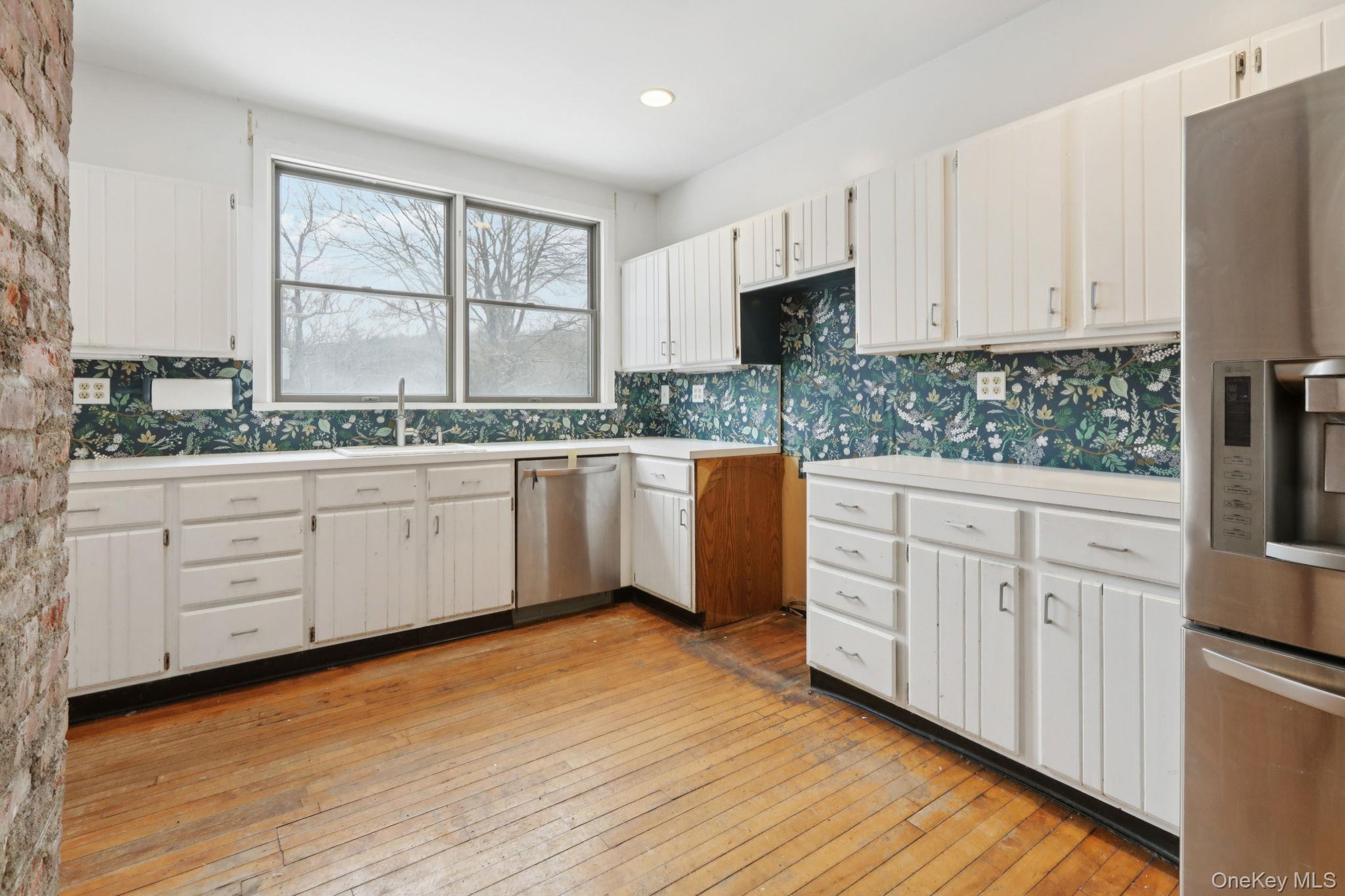32 East Lake Stable Road Tuxedo Park, NY 10987 - Photo 12 of 49 a kitchen with white cabinets sink and window