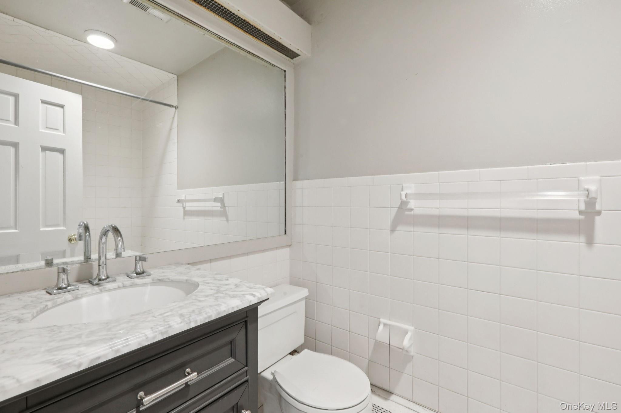32 East Lake Stable Road Tuxedo Park, NY 10987 - Photo 15 of 49 a bathroom with a granite countertop sink toilet and shower