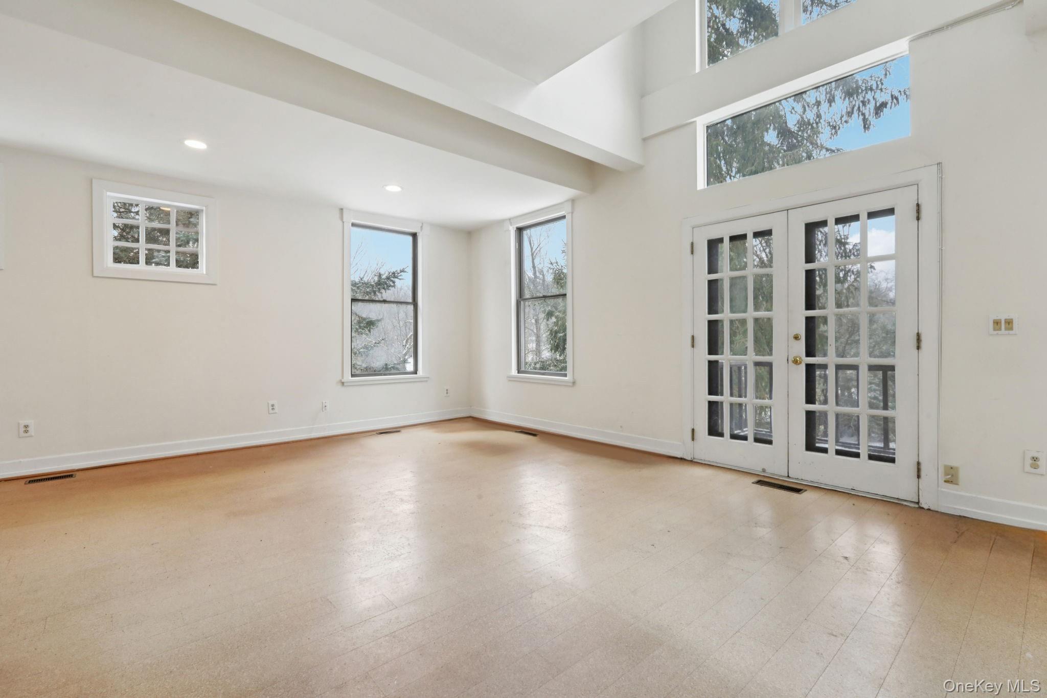 32 East Lake Stable Road Tuxedo Park, NY 10987 - Photo 19 of 49 a view of an empty room with a window and wooden floor