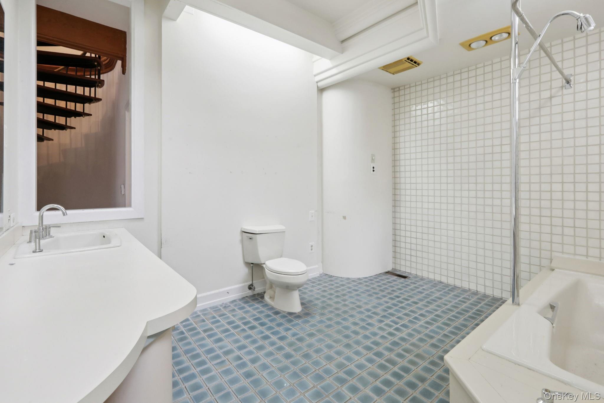 32 East Lake Stable Road Tuxedo Park, NY 10987 - Photo 21 of 49 a bathroom with a sink a toilet and shower