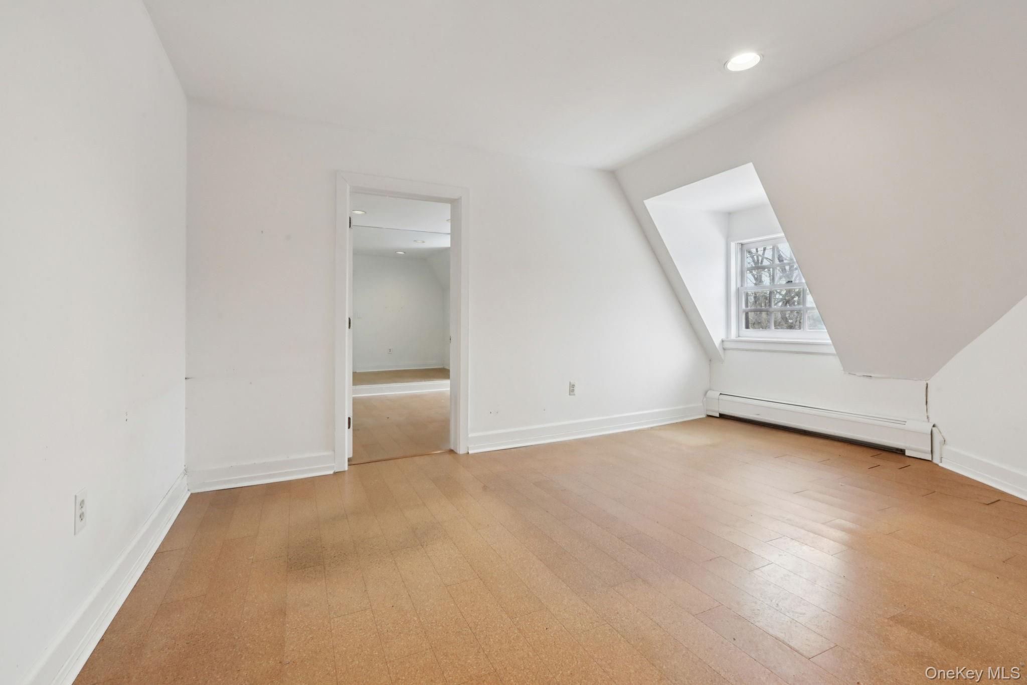 32 East Lake Stable Road Tuxedo Park, NY 10987 - Photo 28 of 49 an empty room with wooden floor and windows