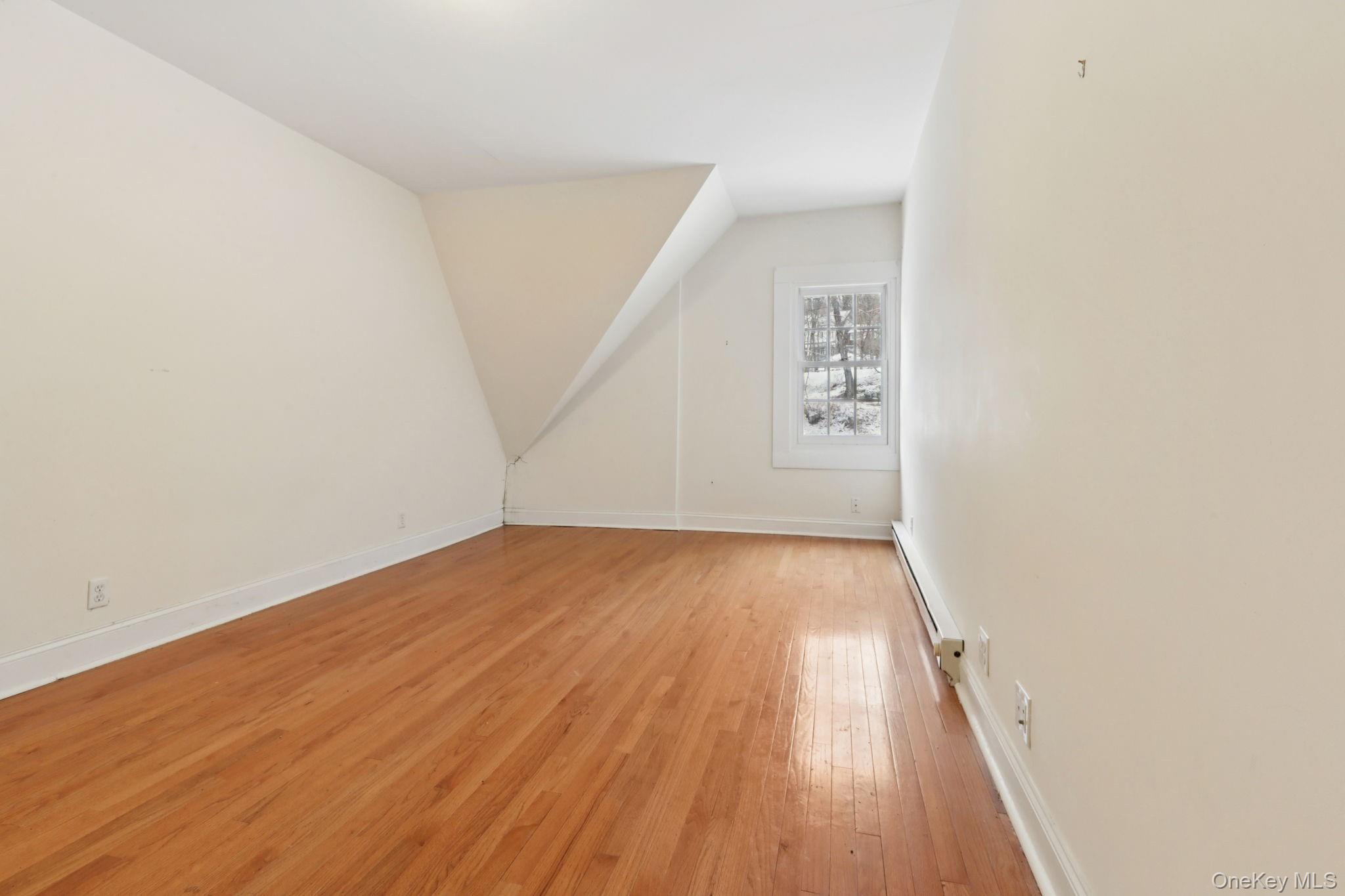 32 East Lake Stable Road Tuxedo Park, NY 10987 - Photo 34 of 49 an empty room with wooden floor and windows