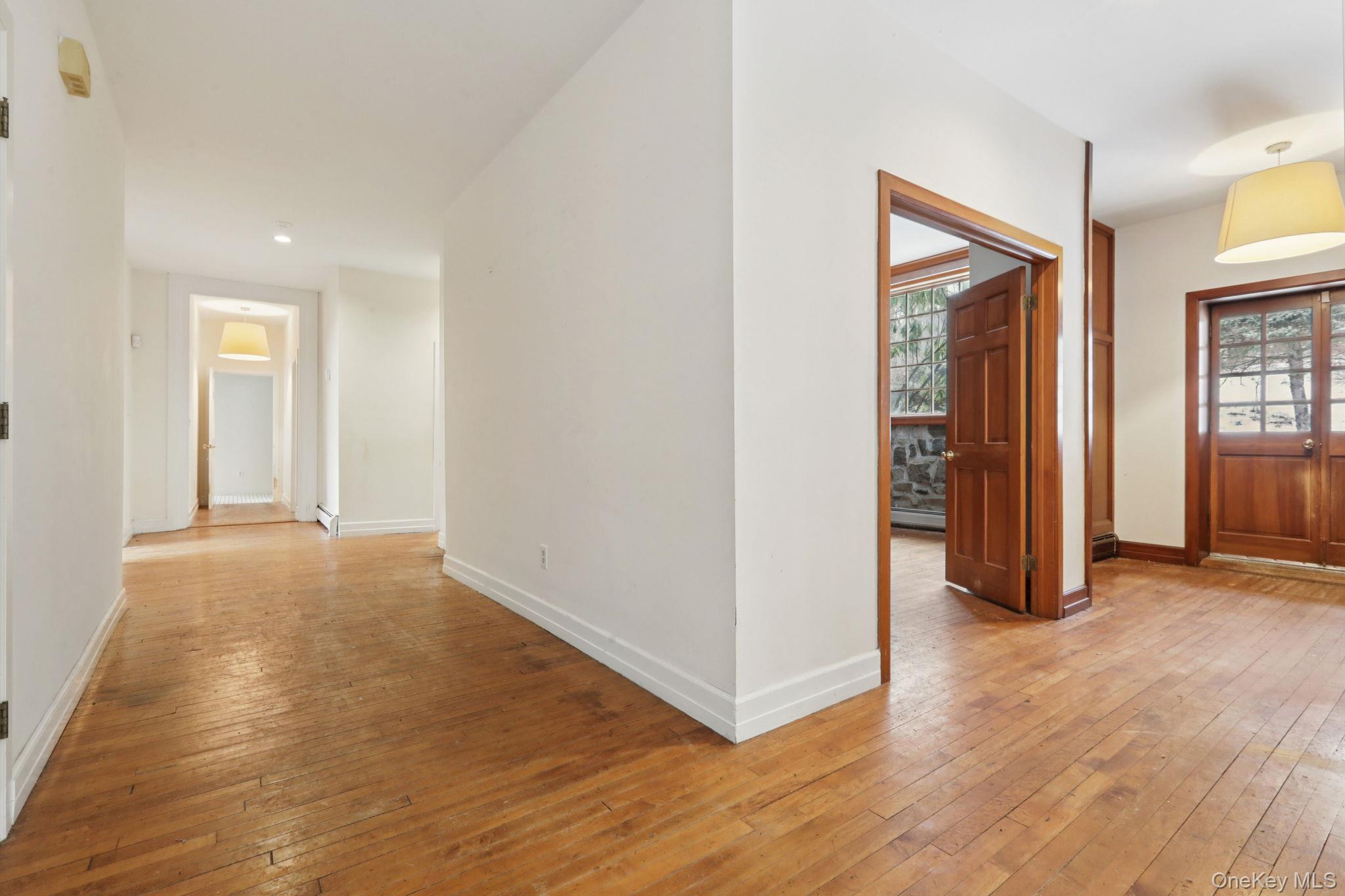 32 East Lake Stable Road Tuxedo Park, NY 10987 - Photo 4 of 49 an empty room with wooden floor and windows
