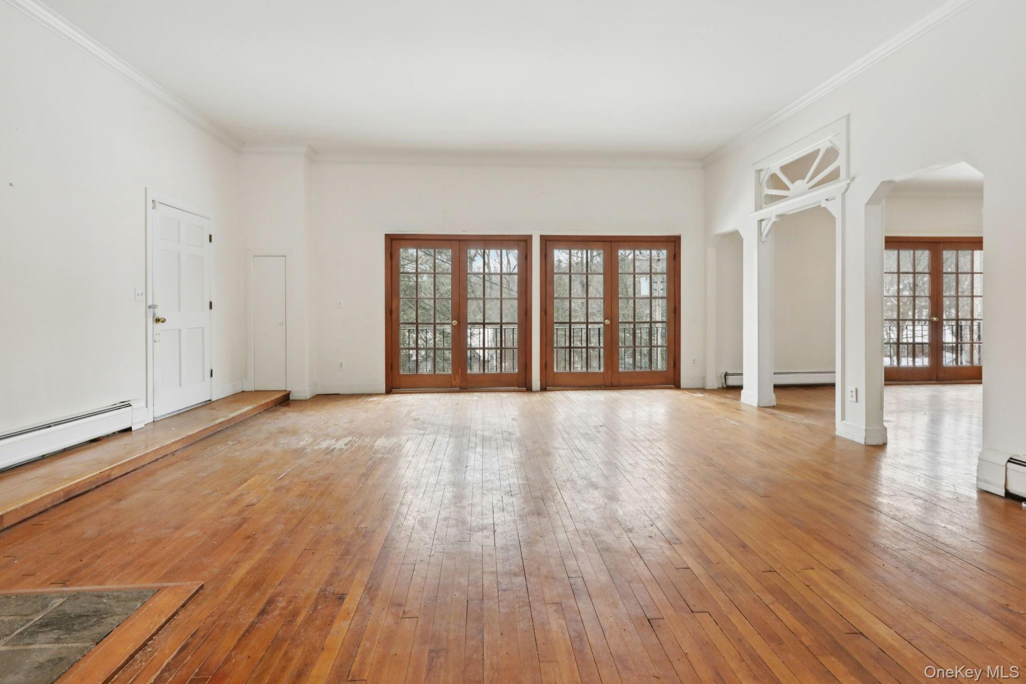 32 East Lake Stable Road Tuxedo Park, NY 10987 - Photo 7 of 49 wooden floor in an empty room with a window