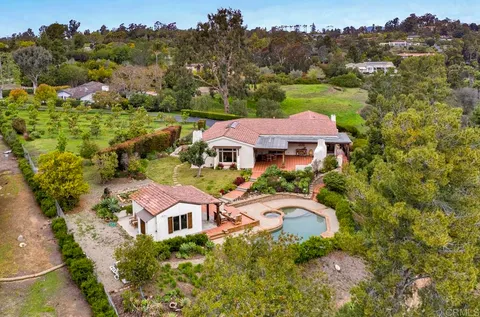 an aerial view of multiple houses with yard