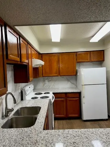 a kitchen with a sink and a refrigerator