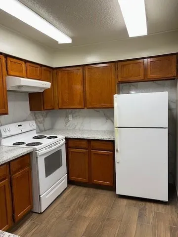 a kitchen with a sink and a refrigerator