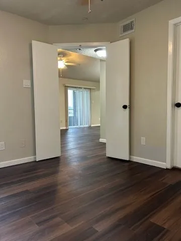 a view of a room with wooden floor and gate