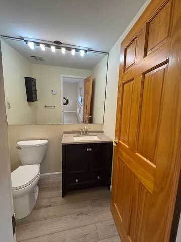 a bathroom with a sink a toilet and mirror