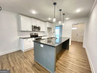 1333 Mooty Bridge Road, Unit 2 LaGrange, GA 30240 - Photo 5 of 17 a large kitchen with stainless steel appliances kitchen island granite countertop a sink counter space and cabinets