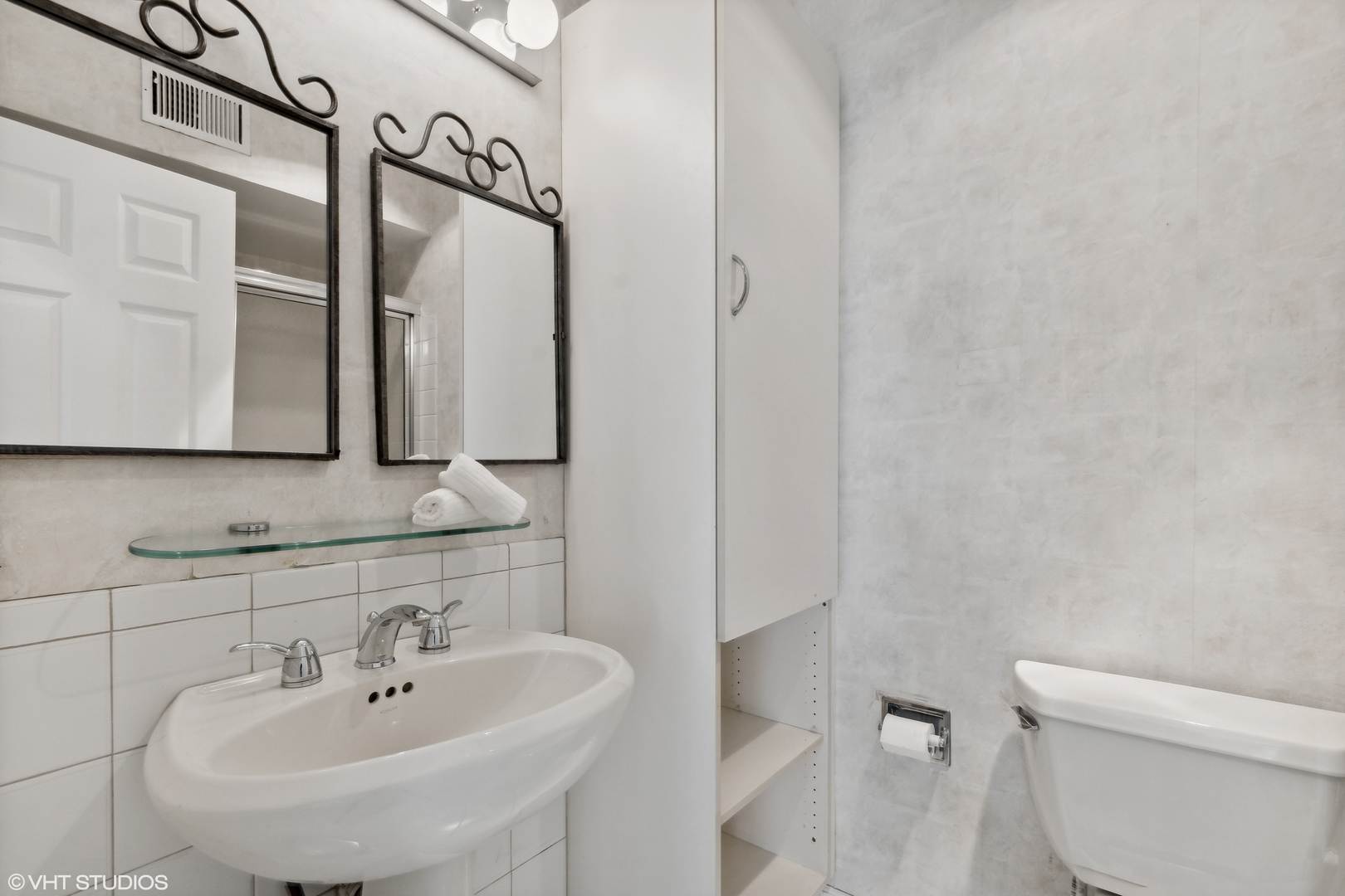 1331 Devonshire Road Buffalo Grove, IL 60089 - Photo 13 of 15 a bathroom with a sink a toilet and mirror