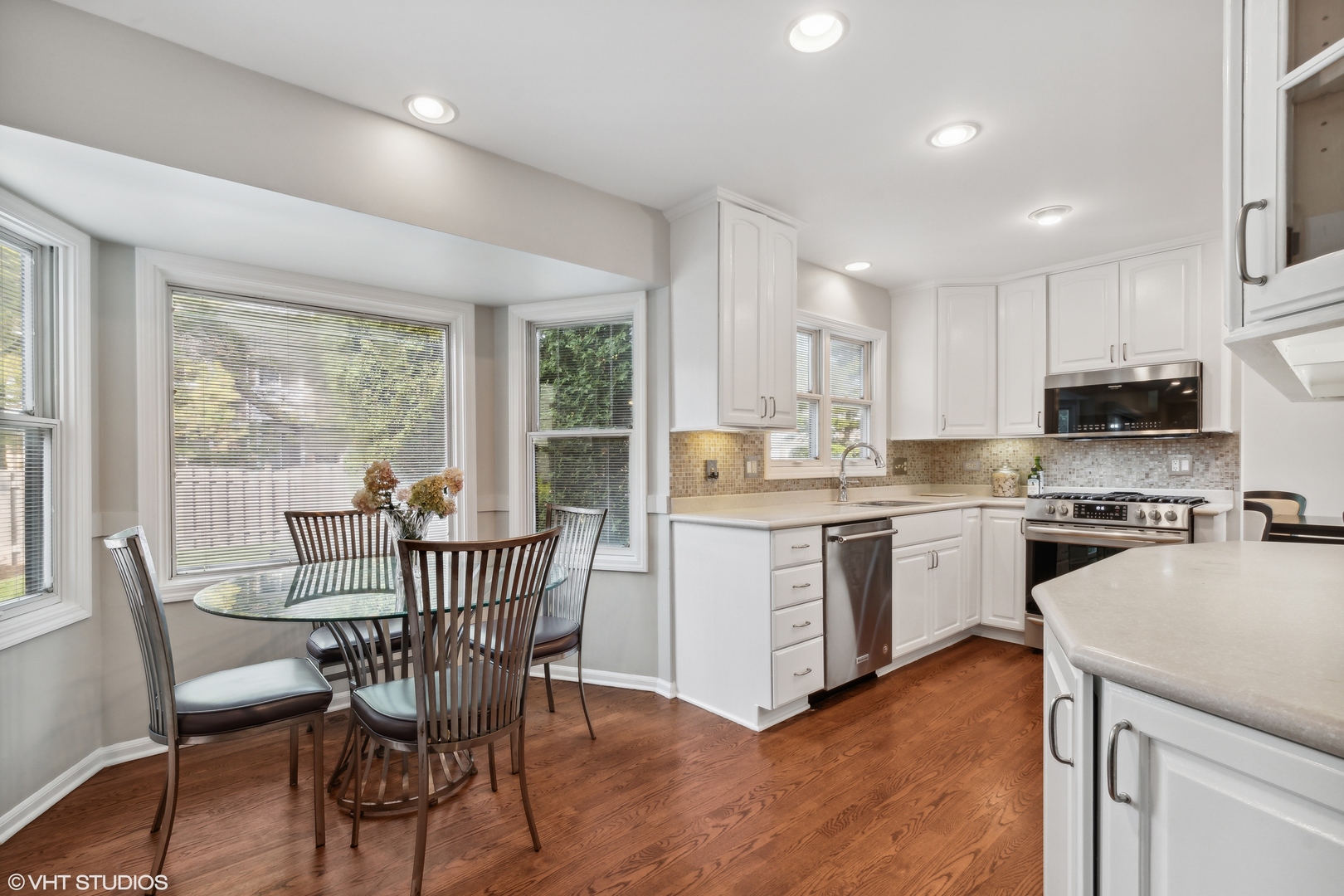 1331 Devonshire Road Buffalo Grove, IL 60089 - Photo 5 of 15 a kitchen with white cabinets and wooden floor