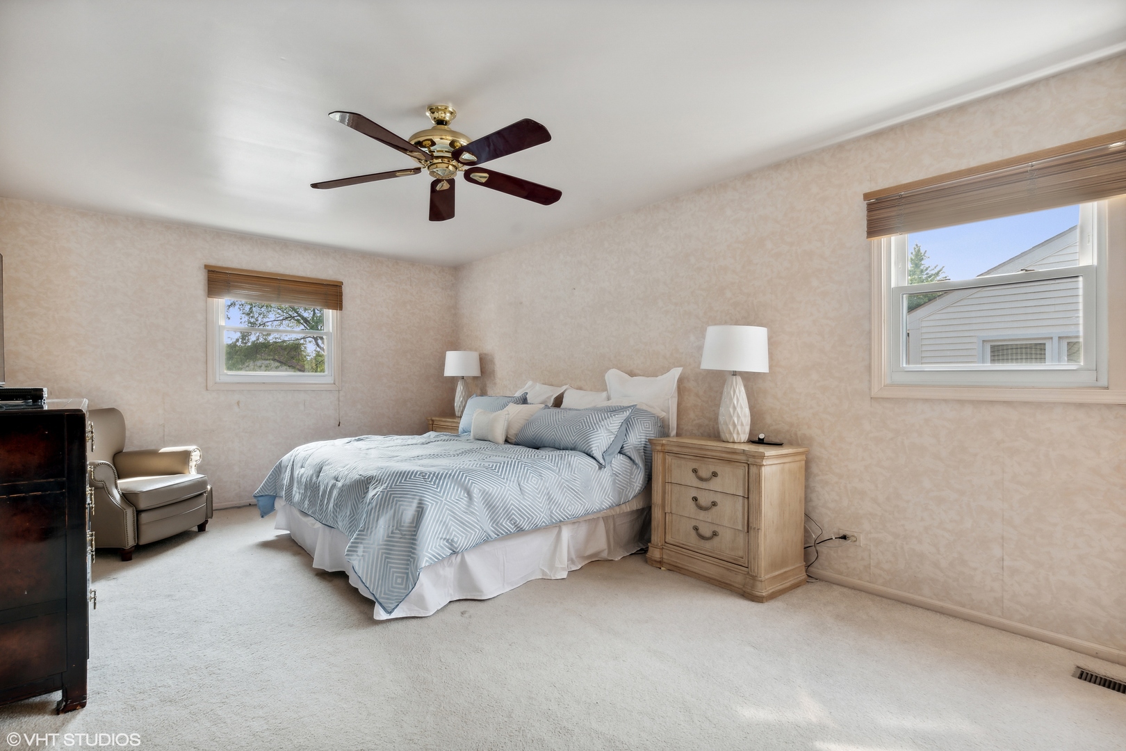 1331 Devonshire Road Buffalo Grove, IL 60089 - Photo 8 of 15 a spacious bedroom with a bed and a chandelier