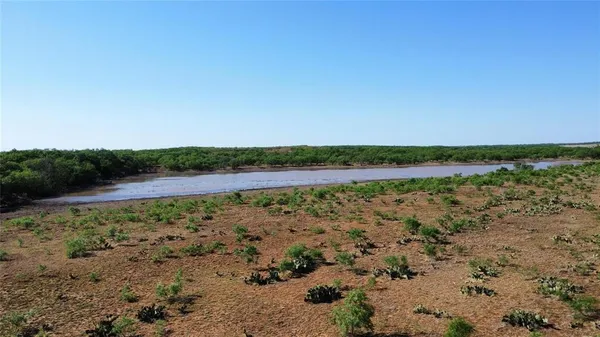 a view of a lake with beach and city view