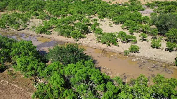 a view of a lake with beach and outdoor space
