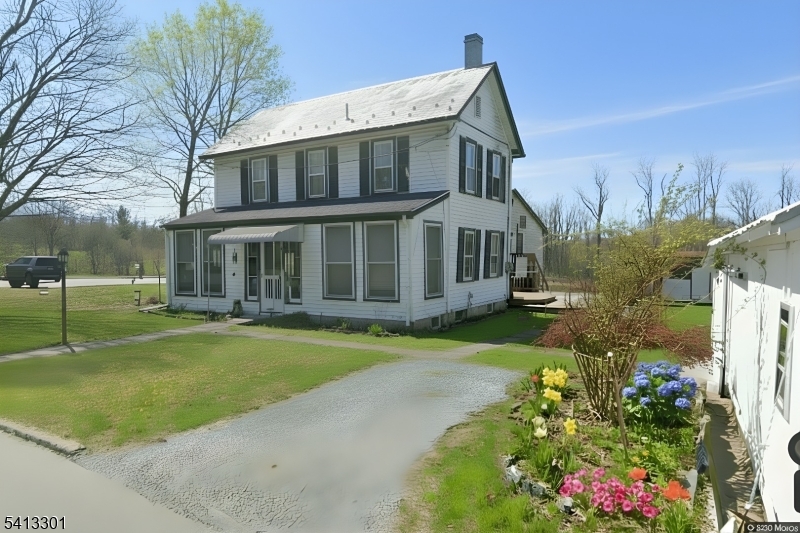 13 Ice Plant Road Lafayette, NJ 07848 - Photo 1 of 14 a front view of a house with a big yard and fountain