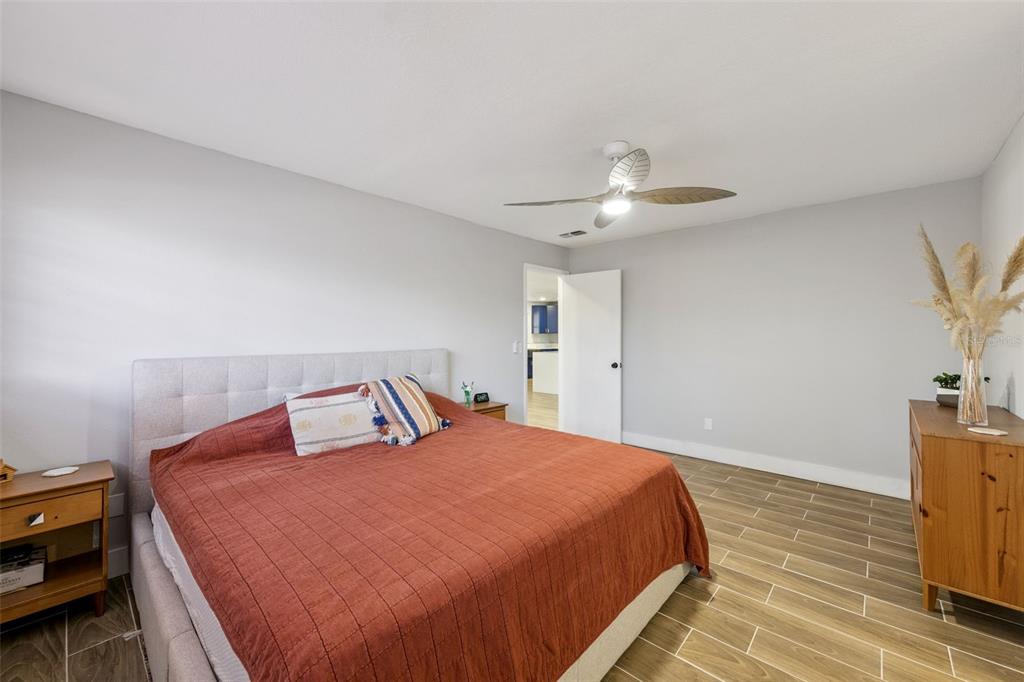 549 Iris Street Altamonte Springs, FL 32714 - Photo 14 of 28 a bedroom with a bed and a chandelier