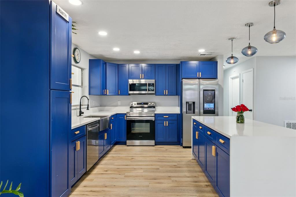 549 Iris Street Altamonte Springs, FL 32714 - Photo 2 of 28 a kitchen with stainless steel appliances granite countertop a refrigerator sink and cabinets