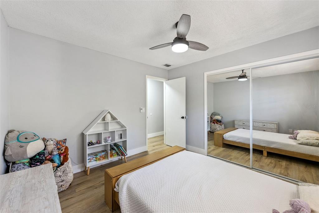 549 Iris Street Altamonte Springs, FL 32714 - Photo 21 of 28 a bedroom with a bed and a chandelier