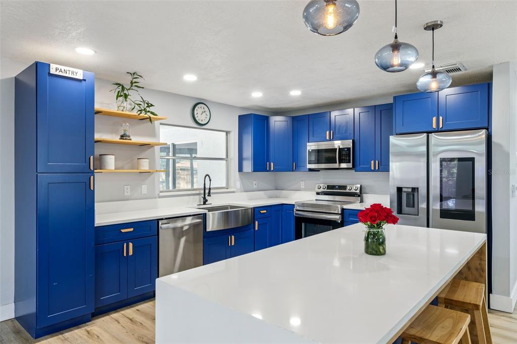 549 Iris Street Altamonte Springs, FL 32714 - Photo 10 of 28 a kitchen with stainless steel appliances granite countertop a sink refrigerator and microwave