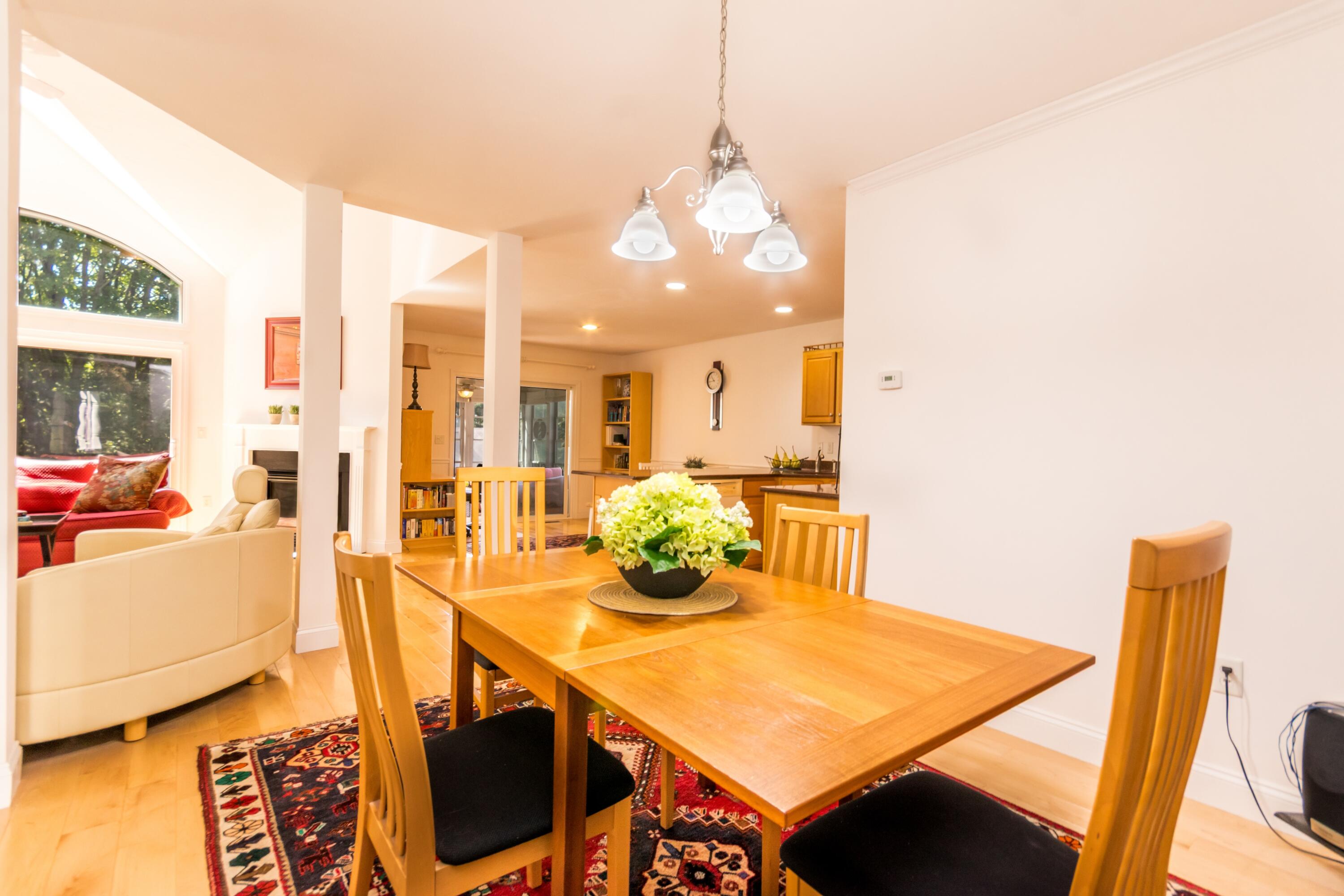26 Carnoustie Road Bourne, MA 02532 - Photo 11 of 46 a view of a dining room with furniture and a chandelier