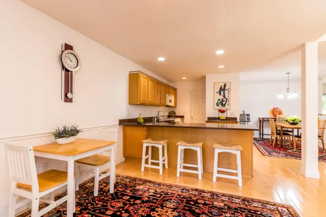 a view of a dining room with furniture and a chandelier