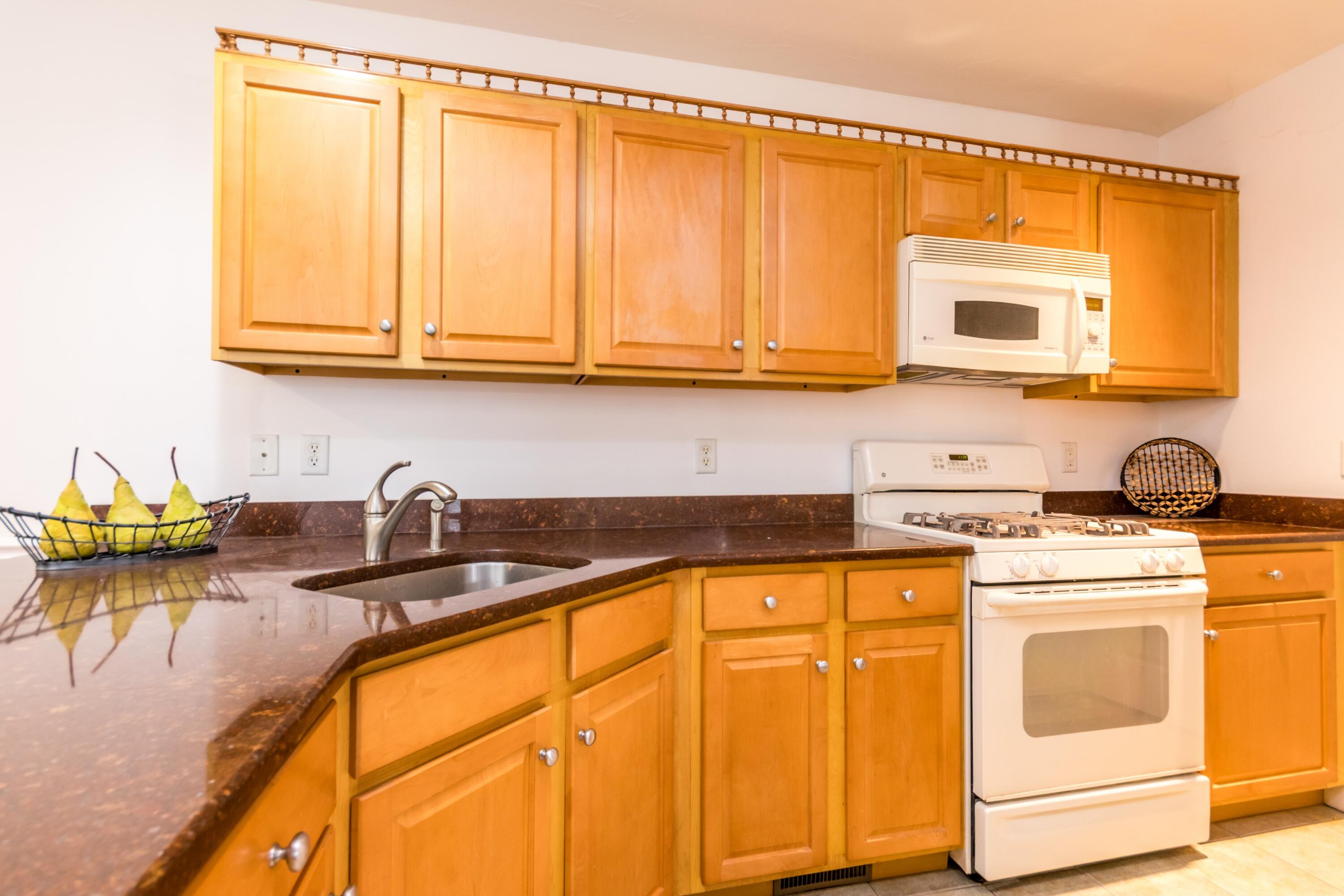26 Carnoustie Road Bourne, MA 02532 - Photo 13 of 46 a kitchen with stainless steel appliances granite countertop a sink a stove and cabinets