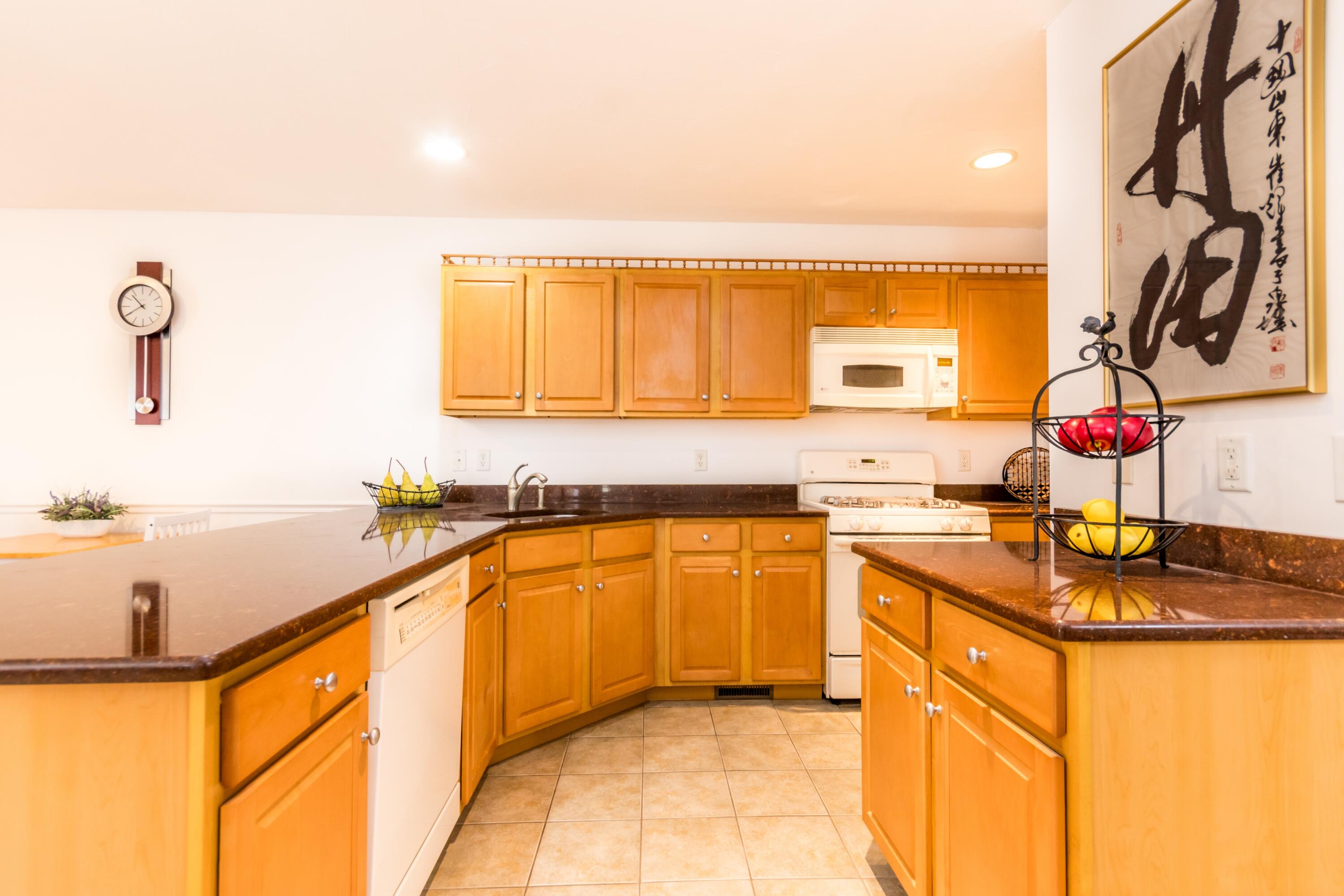 26 Carnoustie Road Bourne, MA 02532 - Photo 14 of 46 a kitchen with stainless steel appliances granite countertop a sink and a stove
