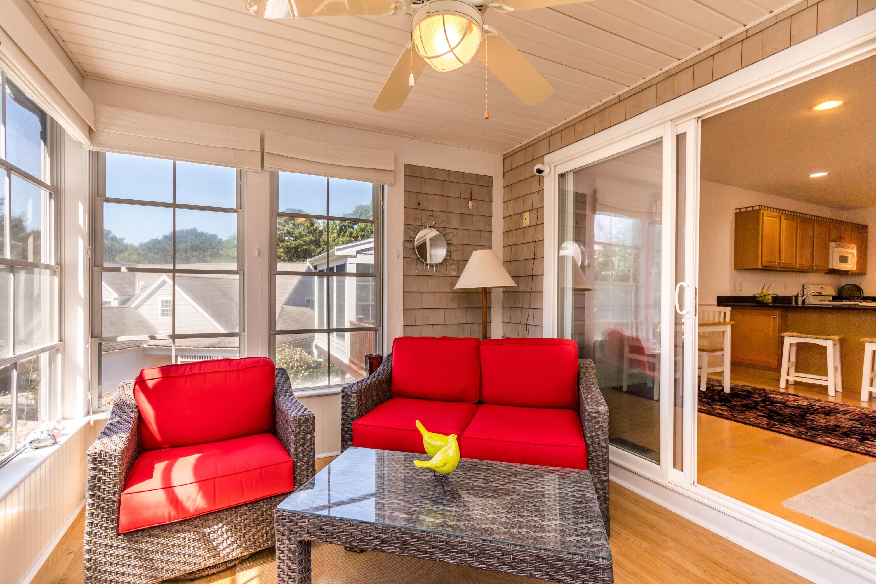 26 Carnoustie Road Bourne, MA 02532 - Photo 16 of 46 a view of a dining room with furniture a chandelier and large windows