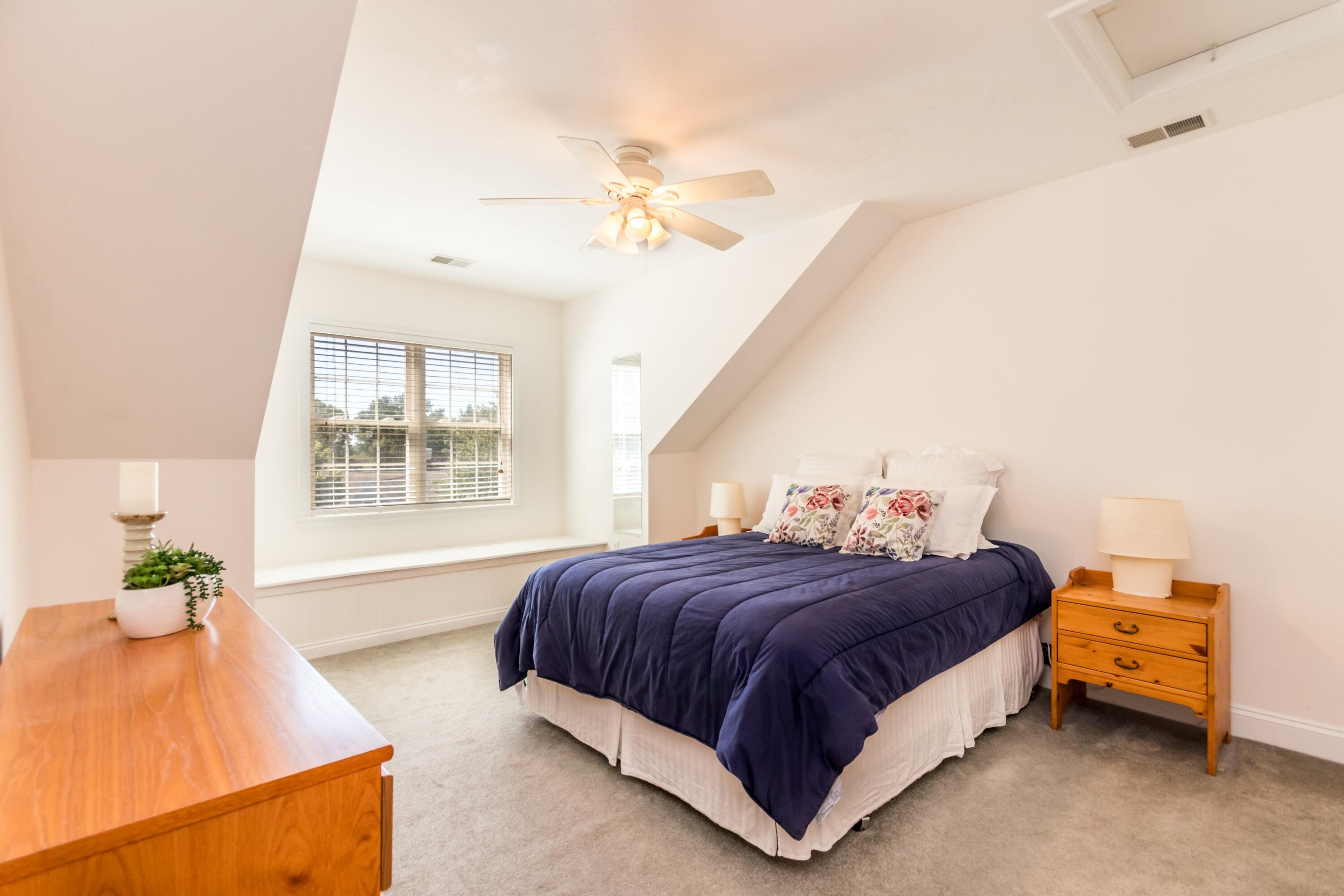 26 Carnoustie Road Bourne, MA 02532 - Photo 24 of 46 a bedroom with a bed and a chandelier