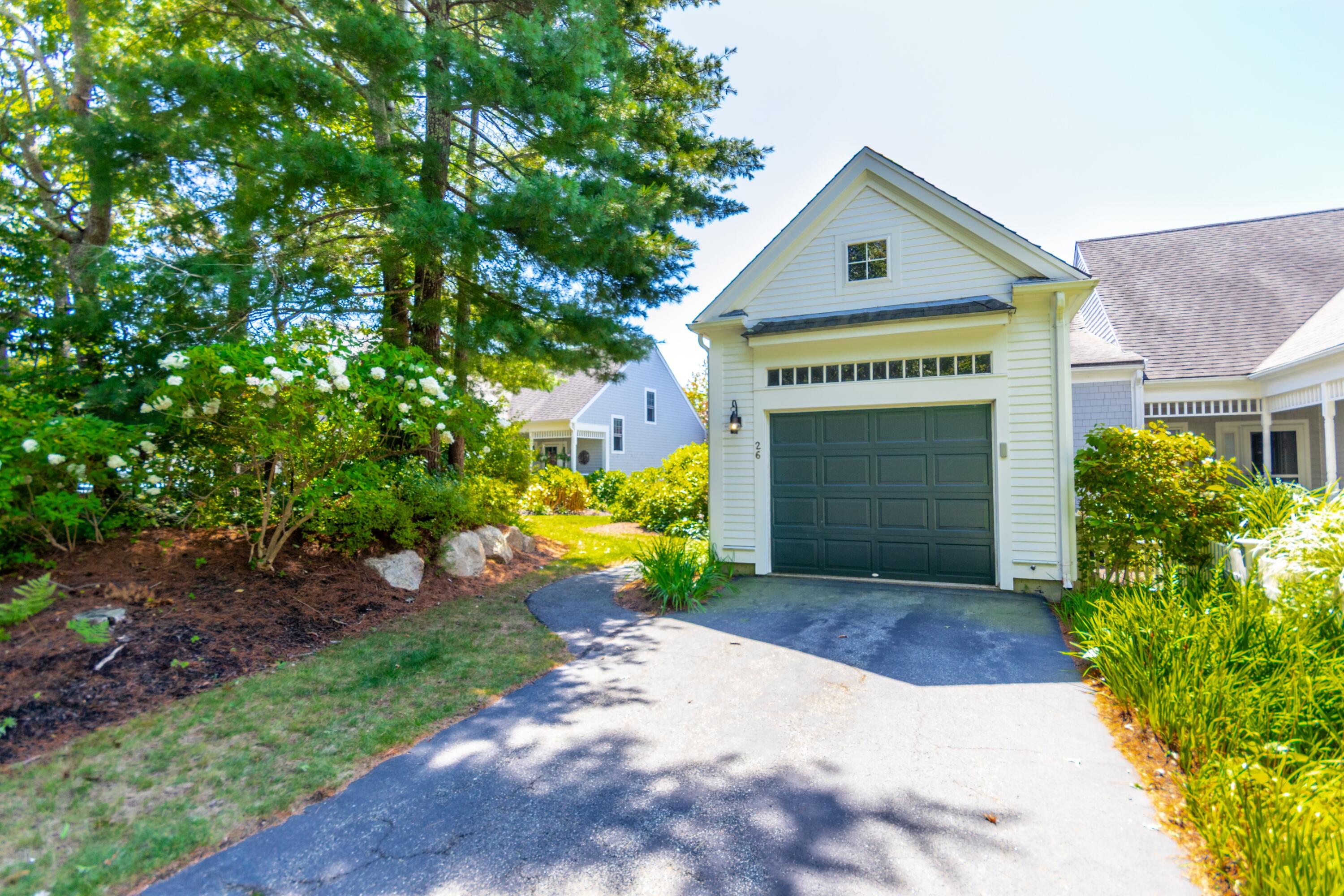 26 Carnoustie Road Bourne, MA 02532 - Photo 3 of 46 a front view of a house with a yard and garage