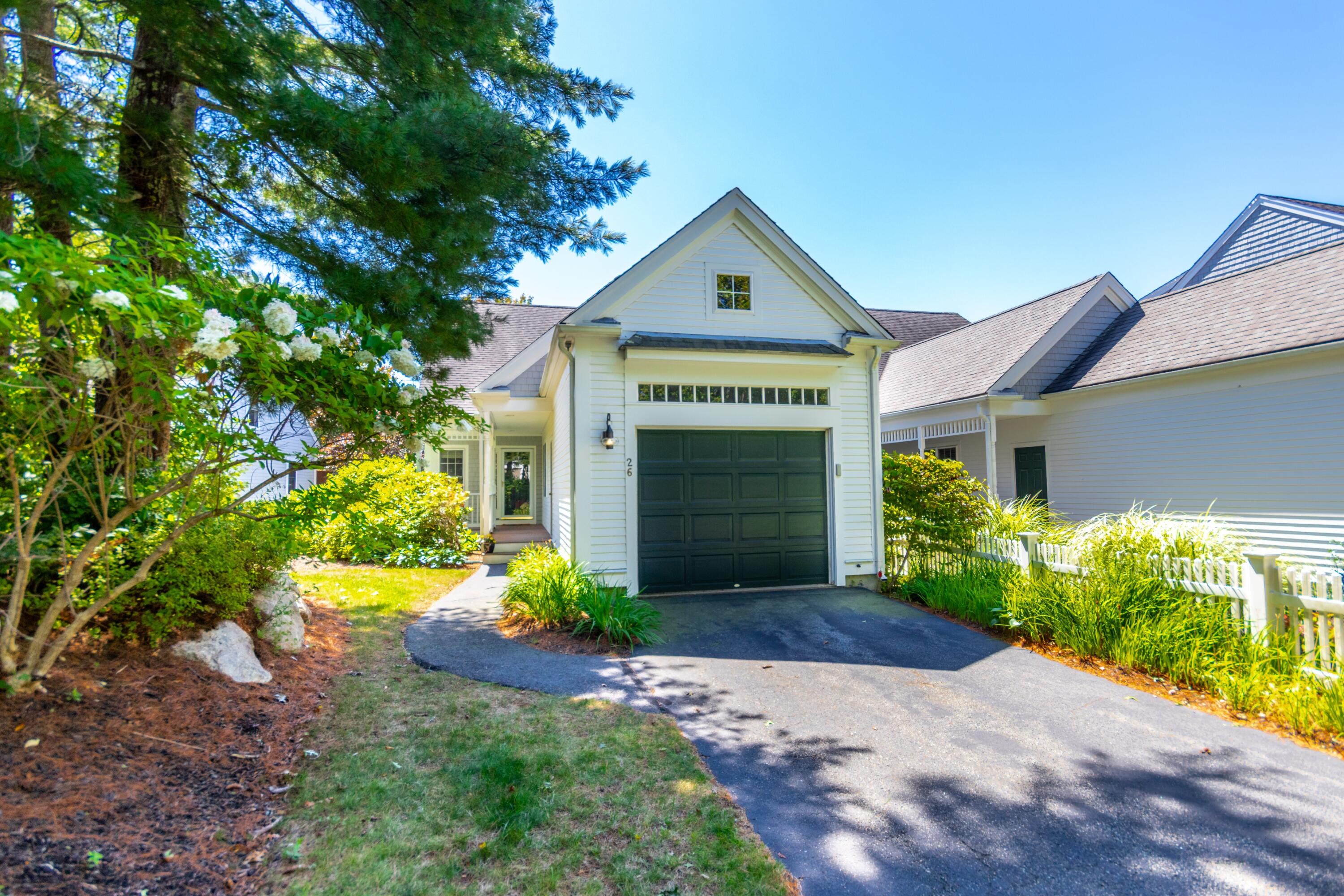 26 Carnoustie Road Bourne, MA 02532 - Photo 33 of 46 a front view of a house with a yard and garage